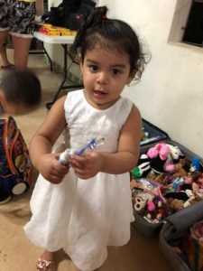 Young girl holding a tooth brush and tooth paste